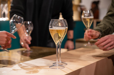 Pouring and tasting of dry sparkling wine champagne on winter weekend festival in December on Avenue de Champagne, Epernay, Champagne region, Franceの写真素材