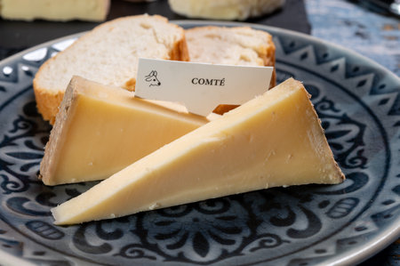 French cheese Comte, three varieties 1 year matured Prestige, fruity flavored Fruite and Vieille Reserve close upの写真素材