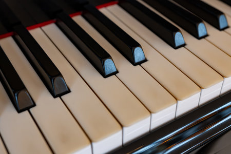 Old grand piano with white ivory keys close upの写真素材