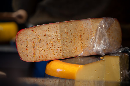 Cutting and tasting of different cheeses and sausages in Dutch cheese farm shopの写真素材