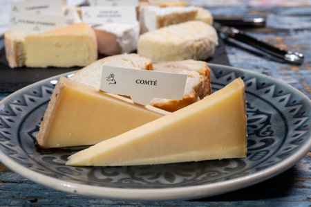 French cheese Comte, three varieties 1 year matured Prestige, fruity flavored Fruite and Vieille Reserve close upの写真素材