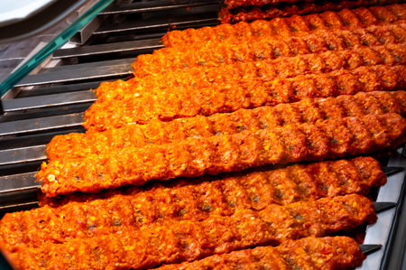 Turkish mixed grill meat, chicken wings, lamb, beef shashlik, kebab cooking on charcoal grill in...