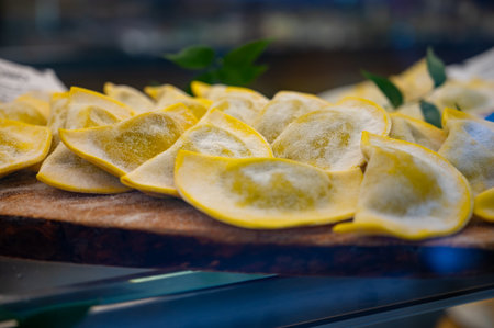 Italian food, fresh homemade stuffed pasta tortelli or ravioli dumplings ready to cook on display, Milan, Lombardy, Italyの写真素材