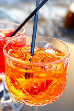 Aperol Spritz orange bitter long drink cocktail made with liqueur, prosecco sparkling wine, ice cubes and piece of orange, Bellagio, Italyの写真素材