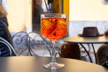 Aperol Spritz orange bitter long drink cocktail made with liqueur, prosecco sparkling wine, ice cubes and piece of orange, Bellagio, Italyの写真素材