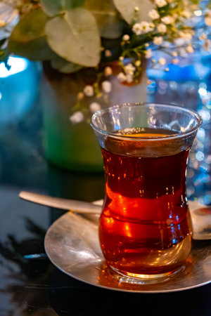 Turkish sweet tea served in traditional glass in restaurant in Istanbul, Turkey, close upの写真素材