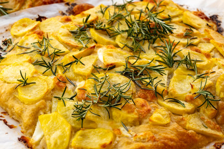 Fresh baked focaccia, pala romana pizza with potato vegetables and rosemary in bakery in Parma, Emilia Romania, Italyの写真素材