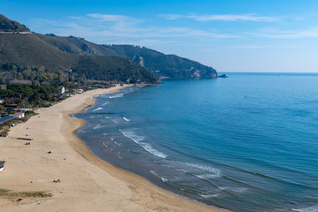 View on sandy beach from hilly medieval small touristic coastal town Sperlonga and sea shore, Latina, Italy in winterの写真素材