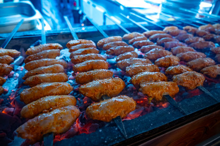 Turkish mixed grill meat, chicken wings, lamb, beef shashlik, kebab cooking on charcoal grill in restaurant in Istanbulの写真素材