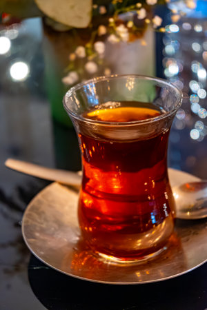 Turkish sweet tea served in traditional glass in restaurant in Istanbul, Turkey, close upの写真素材