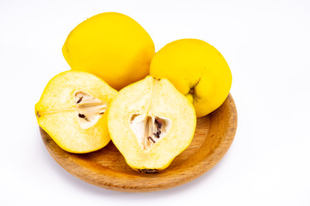Group of ripe yellow quince apples close up on white background isolatedの写真素材