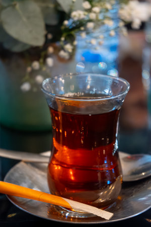 Turkish sweet tea served in traditional glass in restaurant in Istanbul, Turkey, close upの写真素材