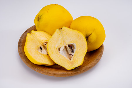 Group of ripe yellow quince apples close up on white background isolatedの写真素材