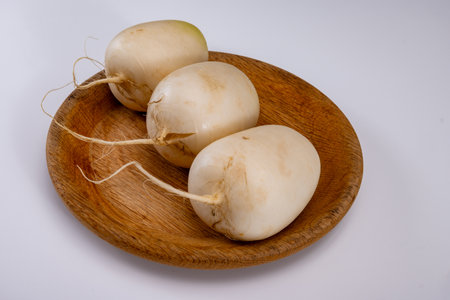 Daikon or mooli Raphanus sativus longipinnatus, mild-flavored winter radish root vegetables on white backgroundの写真素材