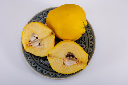 Group of ripe yellow quince apples close up on white background isolatedの写真素材