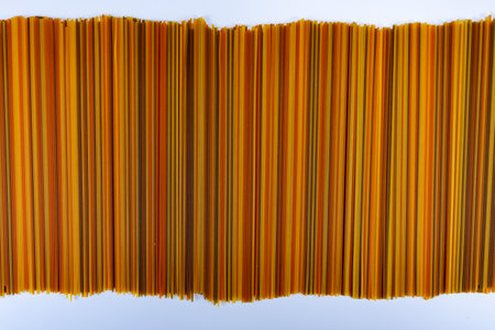 Food background, colorful dried pasta spaghetti, paralleled lines, wallpapers with stripes, restaurant wall decorationの写真素材