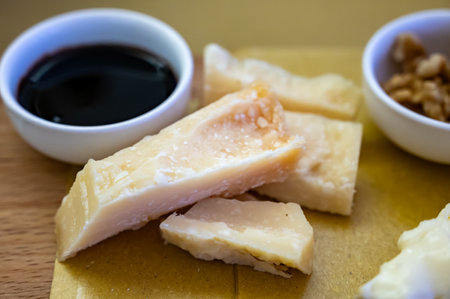 Tasting of different matured and very old parmesan Italian Parmigiano-Reggiano hard cheese and balsamic vinegar of Modena in Parma, Emilia Romagna, Italyの写真素材
