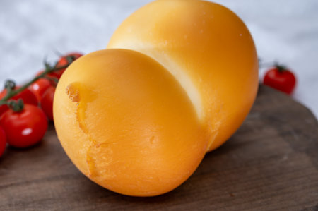 Cheese collection, Italian cheese scamorza, caciocavallo, provolone made from cow milk in South Italy yellow smoked cheese close upの写真素材