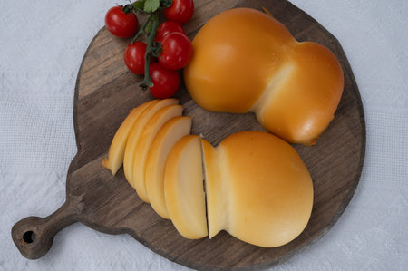 Cheese collection, Italian cheese scamorza, caciocavallo, provolone made from cow milk in South Italy yellow smoked cheese close upの写真素材