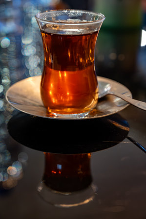 Turkish sweet tea served in traditional glass in restaurant in Istanbul, Turkey, close upの写真素材
