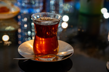 Turkish sweet tea served in traditional glass in restaurant in Istanbul, Turkey, close upの写真素材