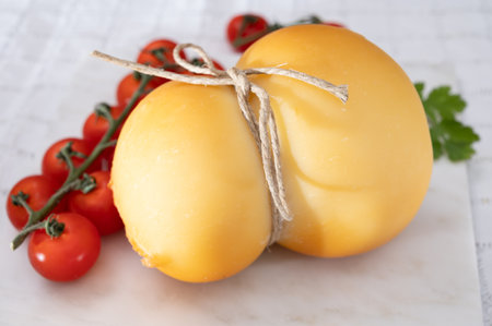 Cheese collection, Italian cheese scamorza, caciocavallo, provolone made from cow milk in South Italy yellow smoked cheese close upの写真素材