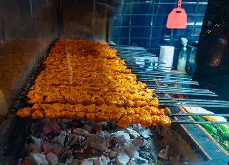 Turkish mixed grill meat, chicken wings, lamb, beef shashlik, kebab cooking on charcoal grill in restaurant in Istanbulの写真素材