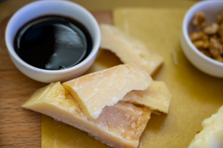 Tasting of different matured and very old parmesan Italian Parmigiano-Reggiano hard cheese and balsamic vinegar of Modena in Parma, Emilia Romagna, Italyの写真素材