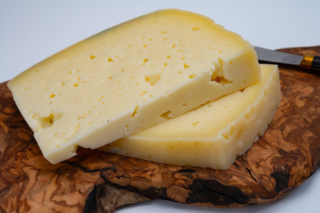 Fresh Asiago cow's milk cheese, produced in Asiago in Italy, different textures according to its aging, used in panini, sandwiches, melted on variety of dishes, classified Swiss-type Alpine cheeseの写真素材