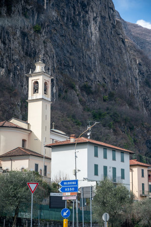 Driving car on road along shores of Lake Como in Northern Italy, spring sunny days, views of alpine mountains, water and villagesの写真素材