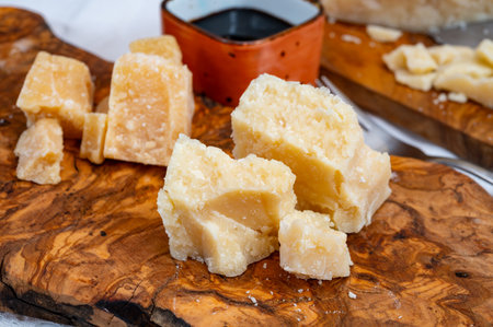 Tasting of 24 and 48 months aged in caves Italian parmesan hard cheese from Parmigiano-Reggiano, Italy and balsamic vinegar from Modenaの写真素材