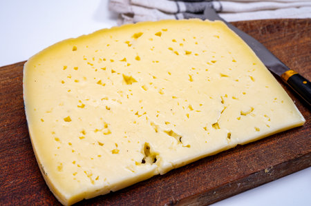 Fresh Asiago cow's milk cheese, produced in Asiago in Italy, different textures according to its aging, used in panini, sandwiches, melted on variety of dishes, classified Swiss-type Alpine cheeseの写真素材