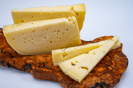 Fresh Asiago cow's milk cheese, produced in Asiago in Italy, different textures according to its aging, used in panini, sandwiches, melted on variety of dishes, classified Swiss-type Alpine cheeseの写真素材