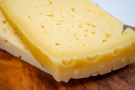 Fresh Asiago cow's milk cheese, produced in Asiago in Italy, different textures according to its aging, used in panini, sandwiches, melted on variety of dishes, classified Swiss-type Alpine cheeseの写真素材