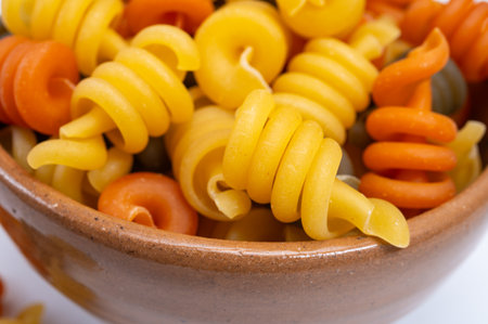 Traditional colorful tricolore Italian dried homemade pasta from Naples, Italy on olive wood boardの写真素材