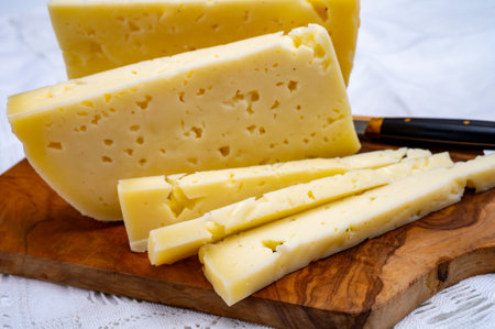 Fresh Asiago cow's milk cheese, produced in Asiago in Italy, different textures according to its aging, used in panini, sandwiches, melted on variety of dishes, classified Swiss-type Alpine cheeseの写真素材
