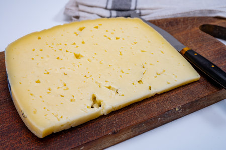 Fresh Asiago cow's milk cheese, produced in Asiago in Italy, different textures according to its aging, used in panini, sandwiches, melted on variety of dishes, classified Swiss-type Alpine cheeseの写真素材