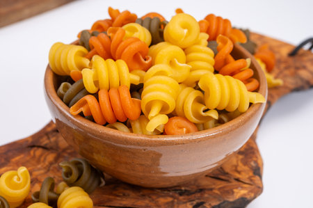 Traditional colorful tricolore Italian dried homemade pasta from Naples, Italy on olive wood boardの写真素材