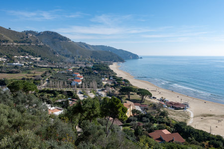 View on sandy beach from hilly medieval small touristic coastal town Sperlonga and sea shore, Latina, Italy in winterの写真素材