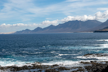 View from south on difficult to access golden sandy long Cofete beach hidden behind mountain range on Fuerteventura, Canary islands, Spainの写真素材