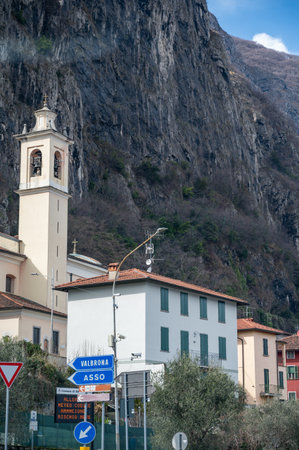 Driving car on road along shores of Lake Como in Northern Italy, spring sunny days, views of alpine mountains, water and villagesの写真素材