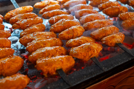 Turkish mixed grill meat, chicken wings, lamb, beef shashlik, kebab cooking on charcoal grill in restaurant in Istanbulの写真素材