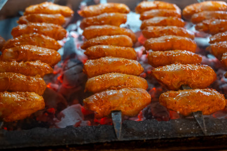 Turkish mixed grill meat, chicken wings, lamb, beef shashlik, kebab cooking on charcoal grill in restaurant in Istanbulの写真素材