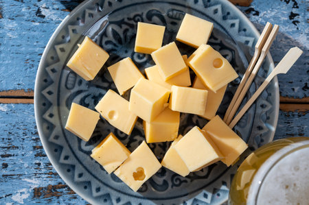 Cheese collection, Dutch ripe hard cheeses made from cow milk in the Netherlands in cubes and glass...