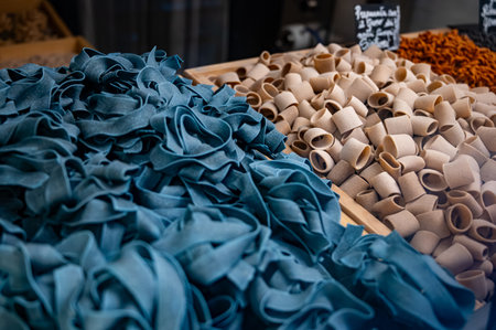 Italian food, dried handmade colorful pasta pappardelle with black spirulina, ready to cook, Milan, Lombardy, Italyの写真素材