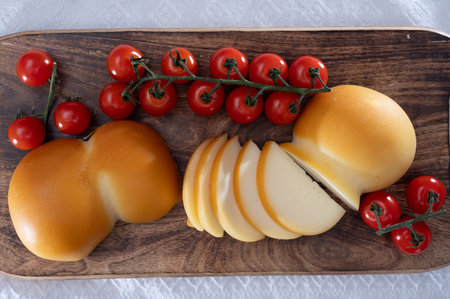 Cheese collection, Italian cheese scamorza, caciocavallo, provolone made from cow milk in South Italy yellow smoked cheese close upの写真素材