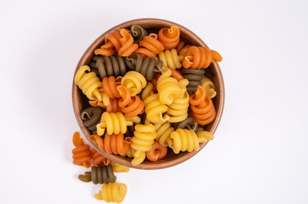 Traditional colorful tricolore Italian dried homemade pasta from Naples, Italy on olive wood board copy spaceの写真素材