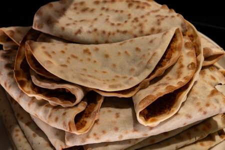 Middle east food, wheat flatbread, naan, stuffed, for sale on Portobello road food market on Saturdays, London, UK, close upの写真素材