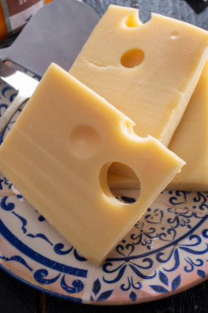 Swiss cheese collection, yellow emmentaler or emmental cheese with round holes sliced close upの写真素材