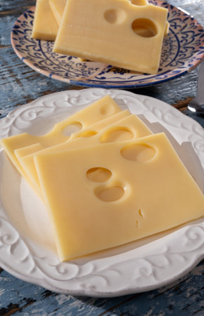 Swiss cheese collection, yellow emmentaler or emmental cheese with round holes sliced close upの写真素材
